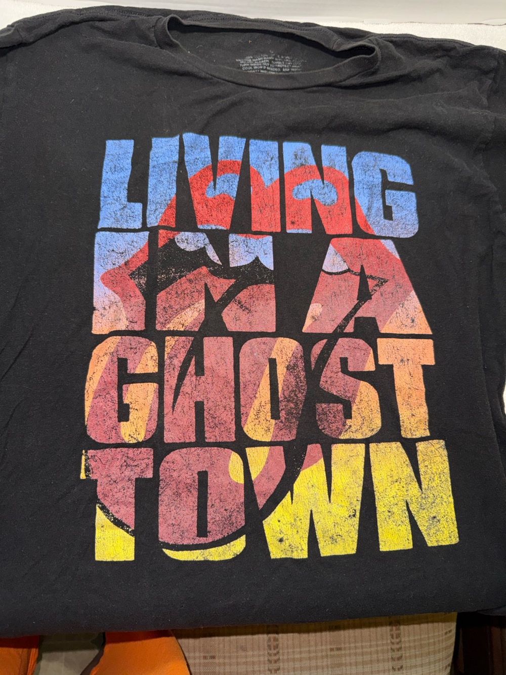 Vintage-Style Black Graphic Band Tee with Multicolor Print.